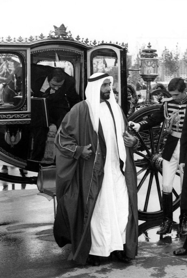 an old black and white photo of two men in front of a carriage