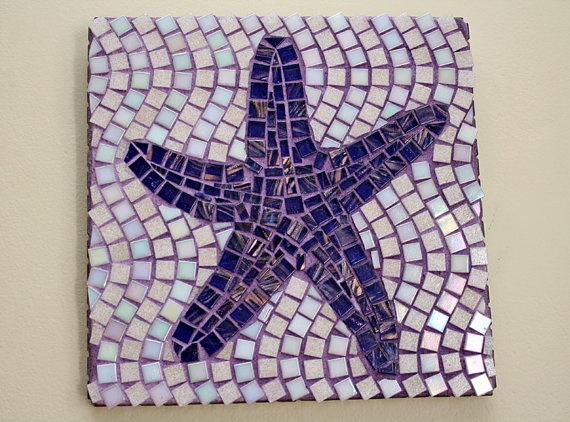 a starfish made out of mosaic tiles on a white wall with purple and blue colors