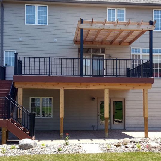 an outside view of a two story apartment building with stairs leading up to the second floor