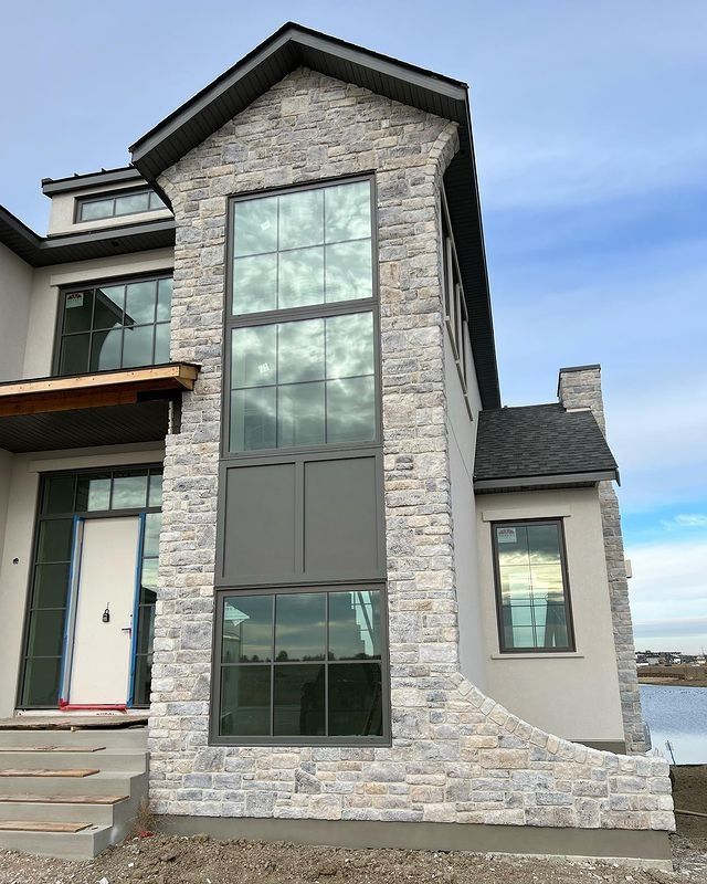 a house that is next to the water and has stairs leading up to its front door