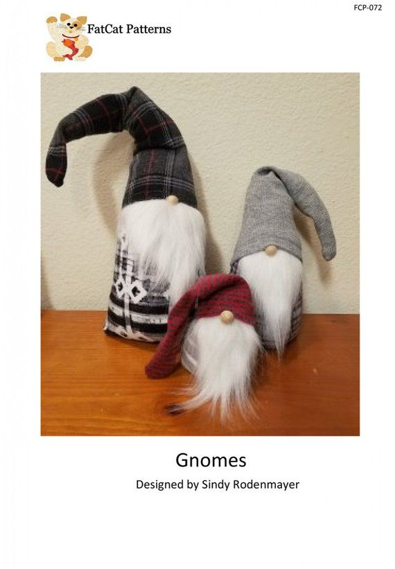 two gnomes are sitting on top of a table with their heads turned upside down