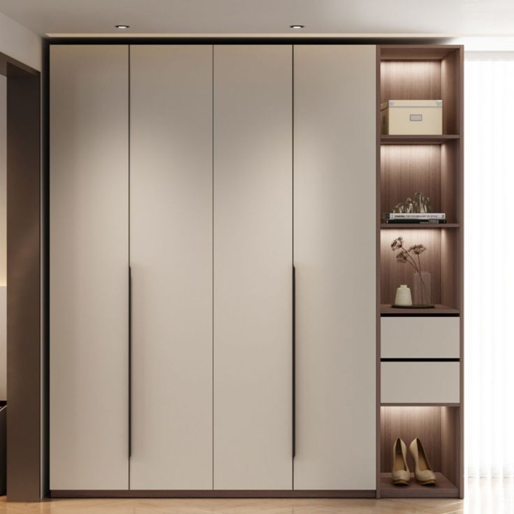 an empty room with white closets and wooden flooring