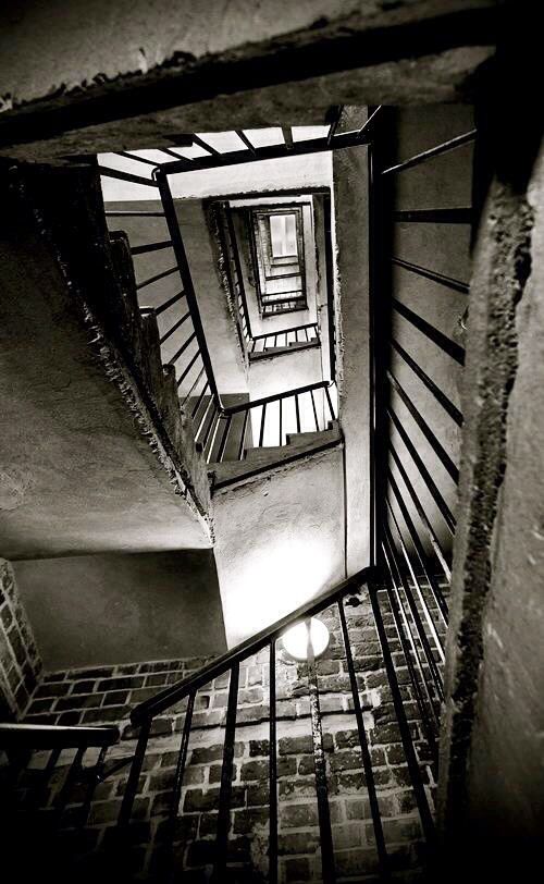 an overhead view of a spiral staircase in black and white