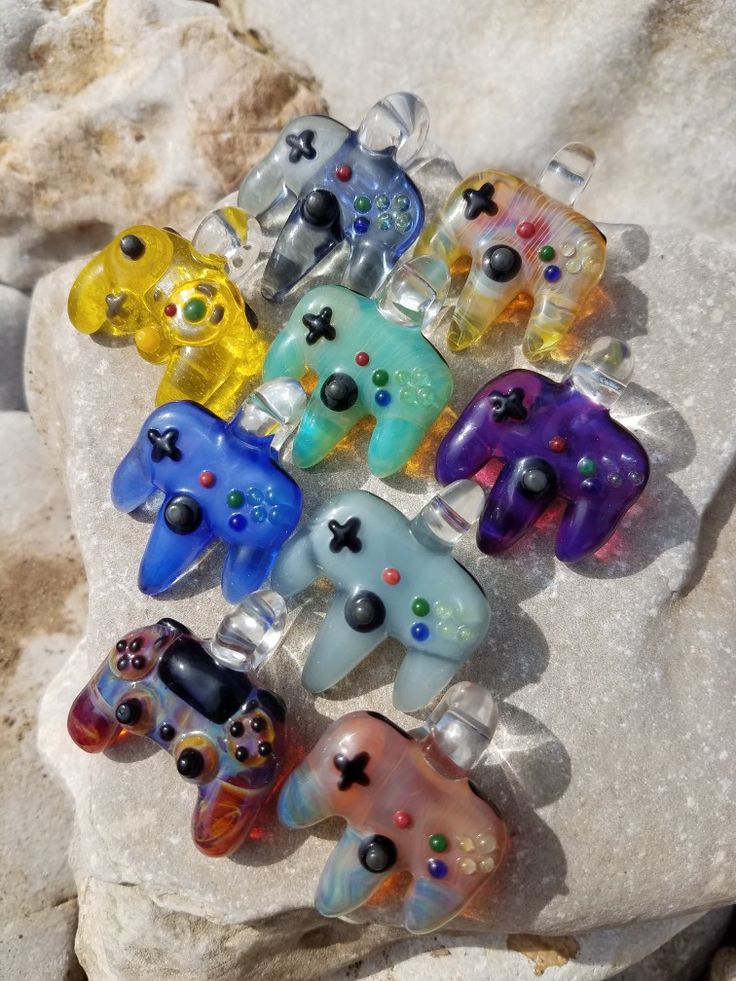 a bunch of glass toys sitting on top of a rock