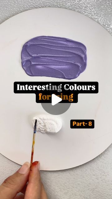 a person is painting on a white plate with purple icing and the words interesting colours for using part 8