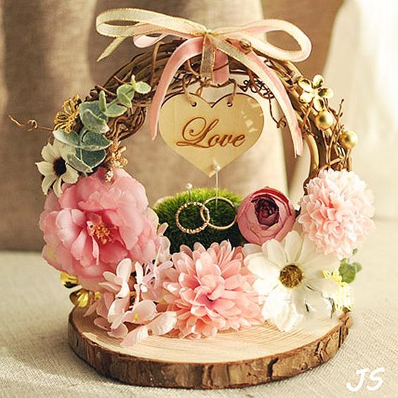 a wooden slice with flowers on it and a sign that says love hanging from the front