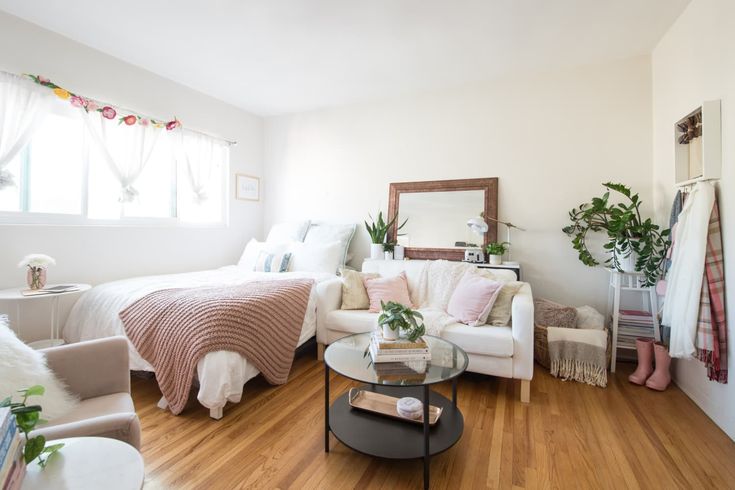 a living room filled with furniture and a bed