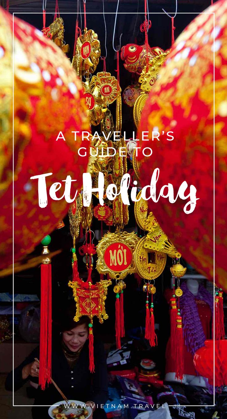 a woman is looking at her phone in front of red and gold decorations with the words traveller's guide to tet holidays