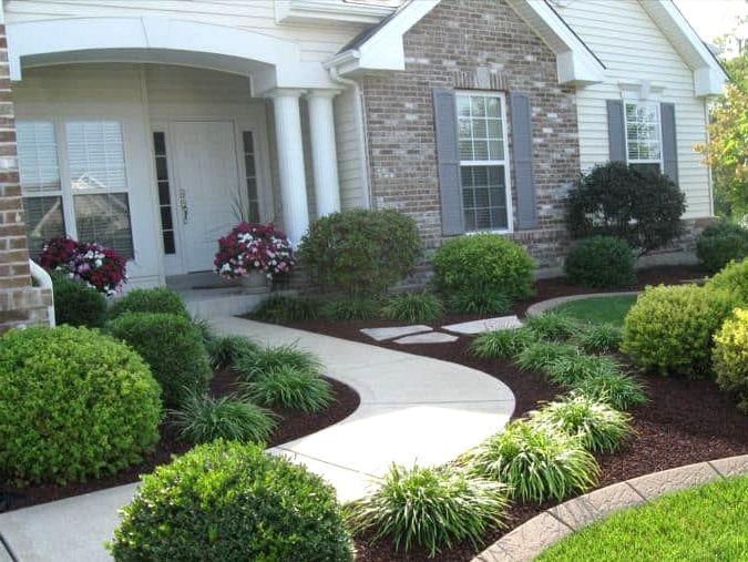 a house with landscaping in front of it