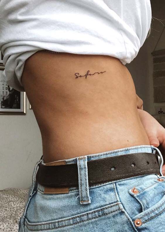 a woman with a small tattoo on her stomach that says, she is not afraid to see