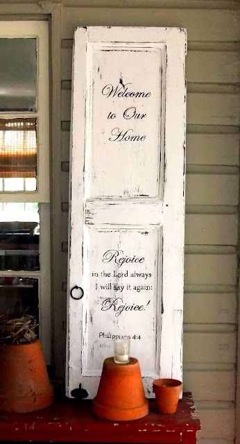 an old white door with the words to our home painted on it's side