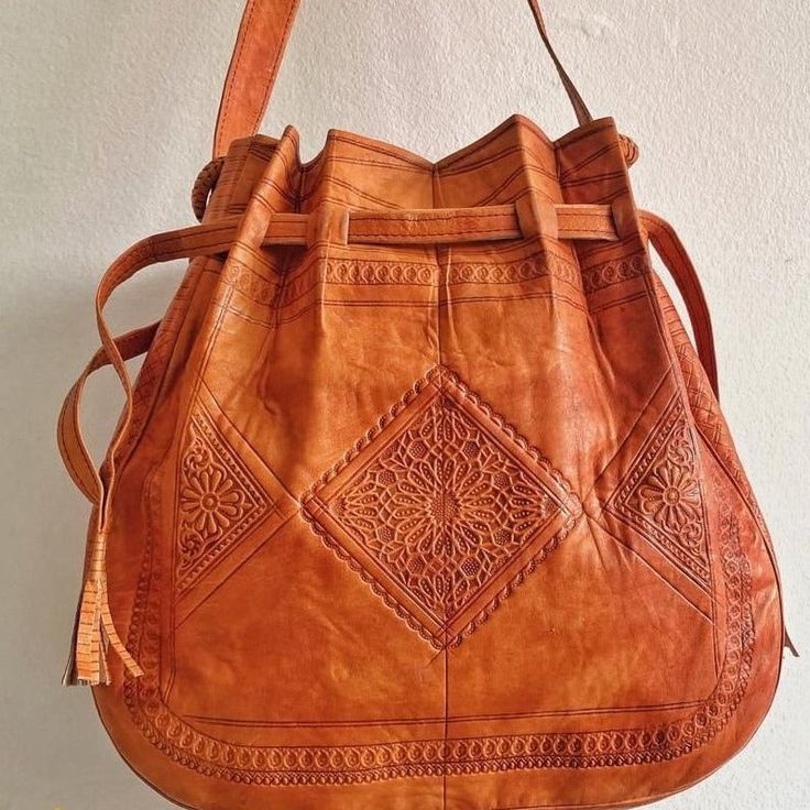 An amazing tan leather boho bag is the best addition to your bohemians bags collection.A stunning piece from our dazzling collection of authentic and stylish Leather crossbody hippie bags crafted in Marrakesh. Handmade and carved, functional, and perfect for office or weekends .Leather with a Boho pattern enhances the rich textural quality of a small bohemian bag crafted from soft leather . - 100% leather- 100% handmade- Long durabilityDimensions : 36 × 34 × 10 cm (H * L * W)Shipping & Delivery Bohemian Crossbody Shoulder Bag With Leather Lining, Bohemian Shoulder Bag With Leather Lining For Travel, Traditional Brown Hobo Bag With Adjustable Strap, Traditional Brown Hobo Bag For Everyday Use, Artisan Leather Shoulder Bag For Festival, Bohemian Brown Satchel With Leather Lining, Bohemian Soft Leather Crossbody Bag, Bohemian Crossbody Bag With Leather Lining, Handmade Bohemian Leather Shoulder Bag