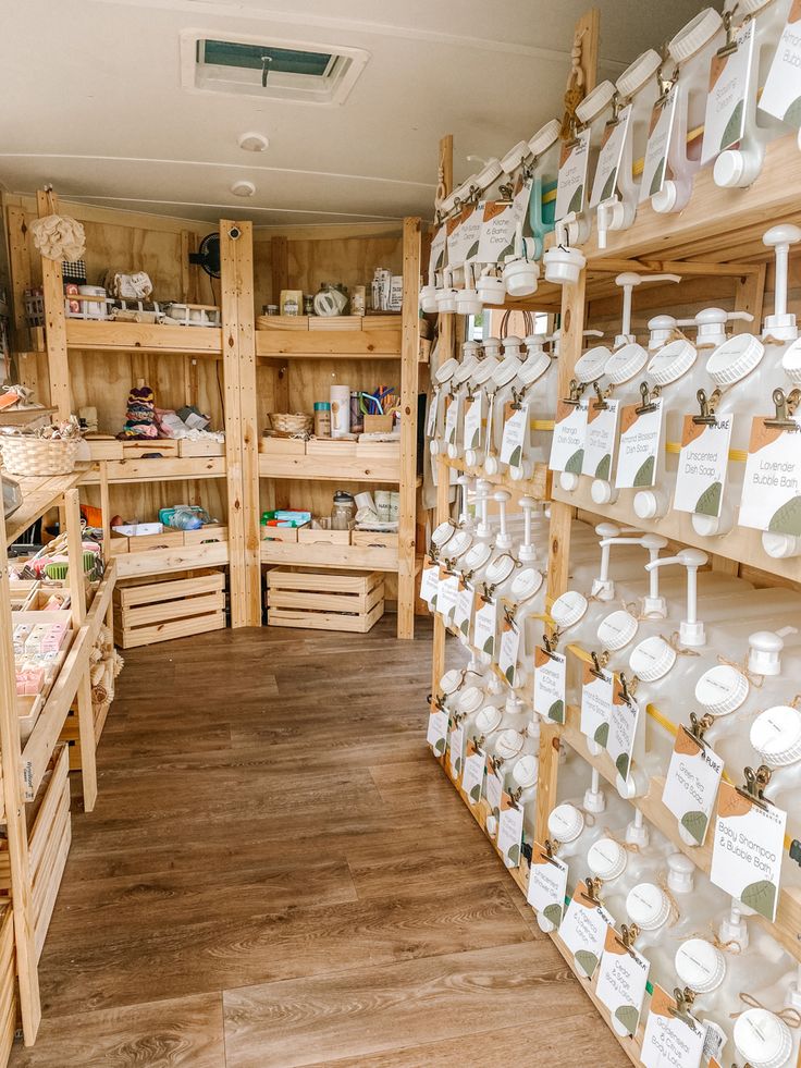 a store filled with lots of wooden shelves covered in white plates and cups on top of them