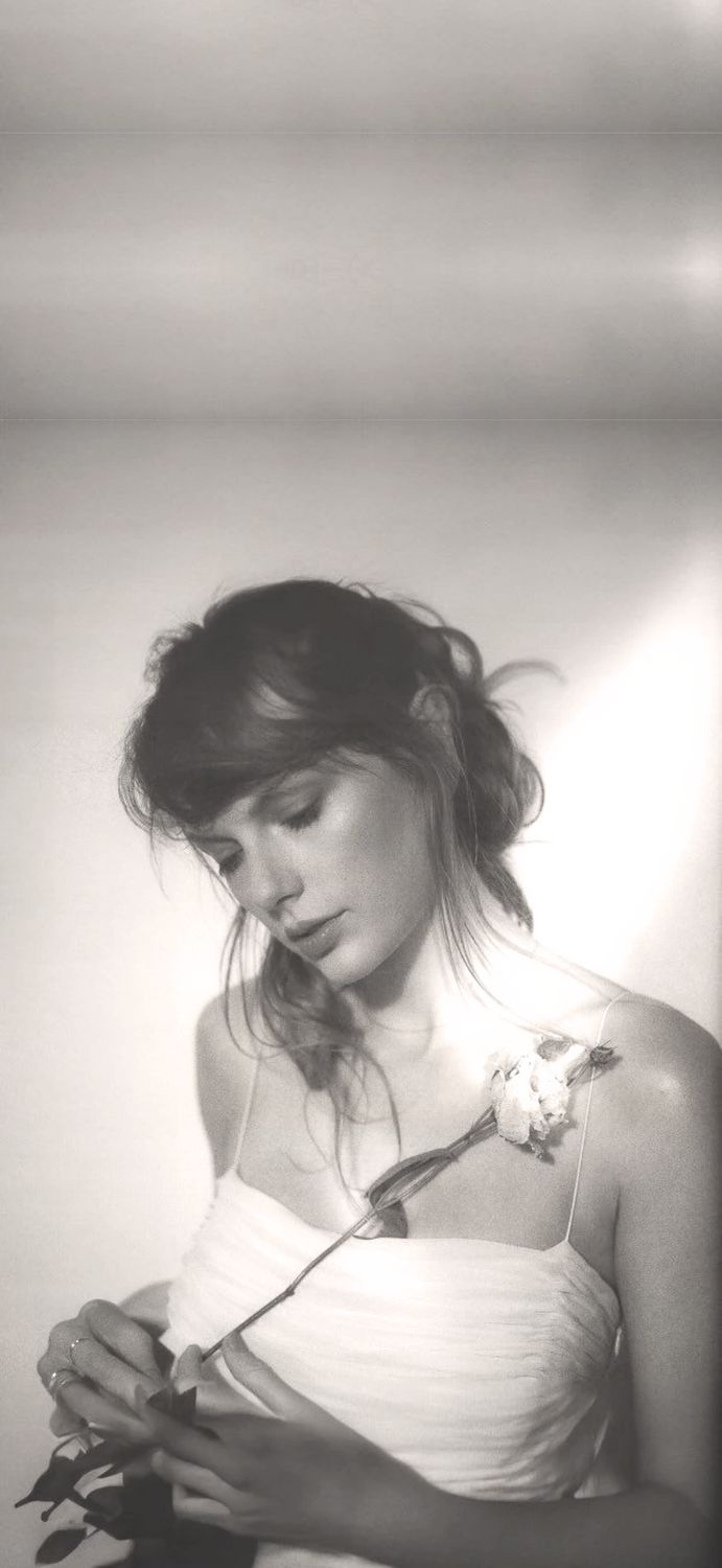 black and white photograph of a woman holding flowers