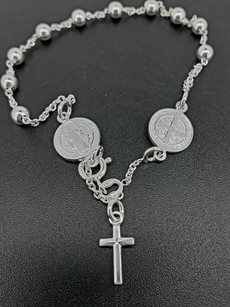 Stylish 925 Sterling Silver rosary bracelet, Catholic Rosary bracelet with Saint Benedict, 4mm sparkle ball chain, a perfect gift for her or him with diamond cuts. These rosaries are stamped 925 for authenticity and are fully adjustable.  We proudly stand behind the quality of our products and prioritize your satisfaction above all else. If, for any reason, you are not completely satisfied with your purchase, we offer hassle-free returns with full refunds of the purchase price. Your happiness is Nickel-free Silver Cross Rosary Bracelet, Sterling Silver Rosary Bracelet Gift, Sterling Silver Rosary Bracelet With Round Beads, Adjustable Silver Cross Rosary Bracelet, Sterling Silver Rosary Bracelet With Round Beads As Gift, Spiritual Silver Charm Bracelet With Cross, Spiritual Silver Cross Charm Bracelet, Silver Rosary Bracelet With 8mm Beads As Gift, Silver Cross Jewelry With 8mm Beads