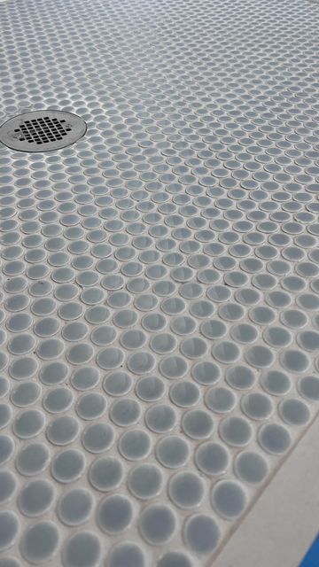 a close up view of the surface of a swimming pool with circles and dots on it