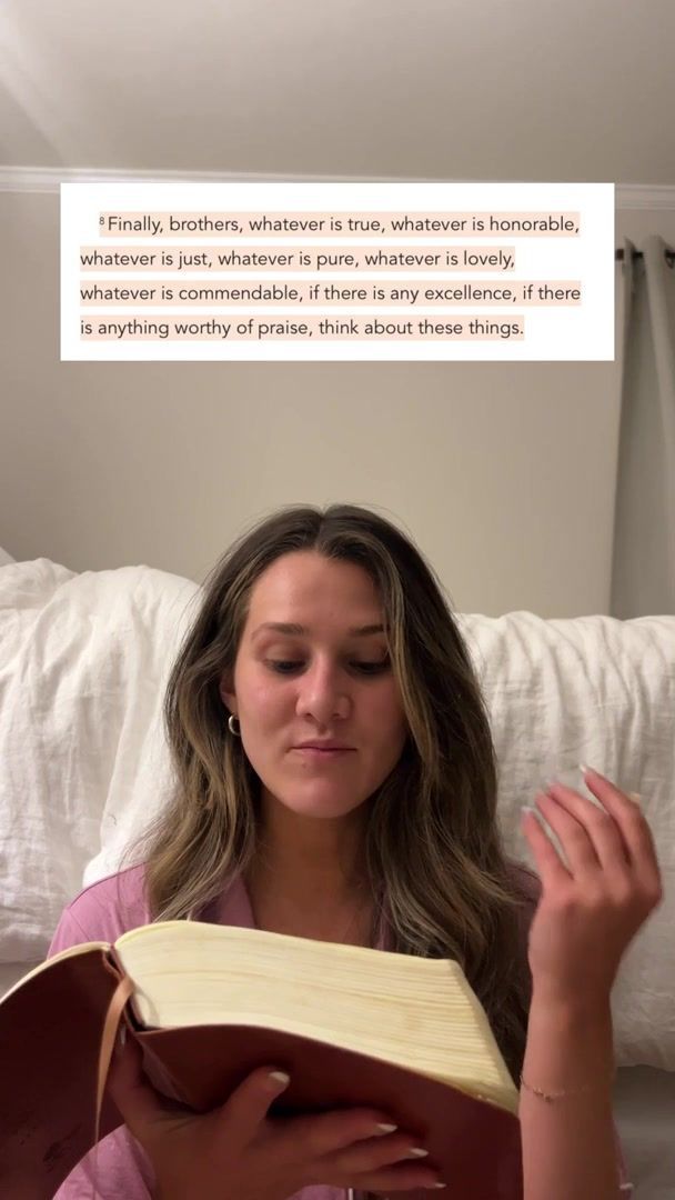 a woman sitting on a bed reading a book with a quote above her head that reads, finally brothers, whatever is true, whatever is