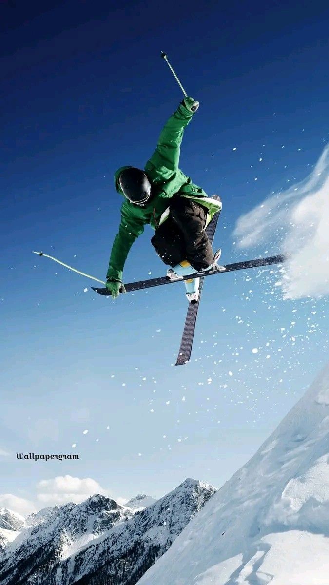 a man flying through the air while riding skis