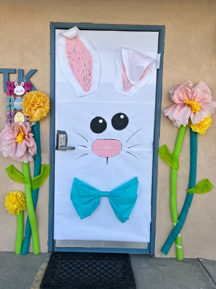 a door decorated with paper flowers and bunny ears