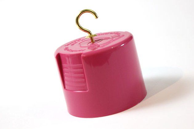 a pink container with a gold hook on it