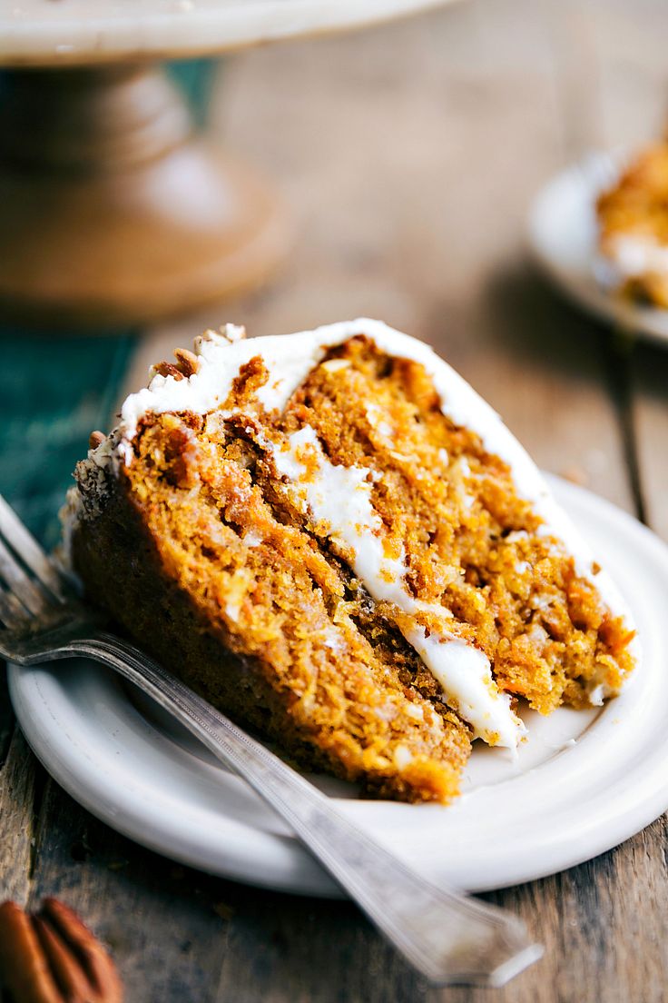 a slice of carrot cake on a white plate