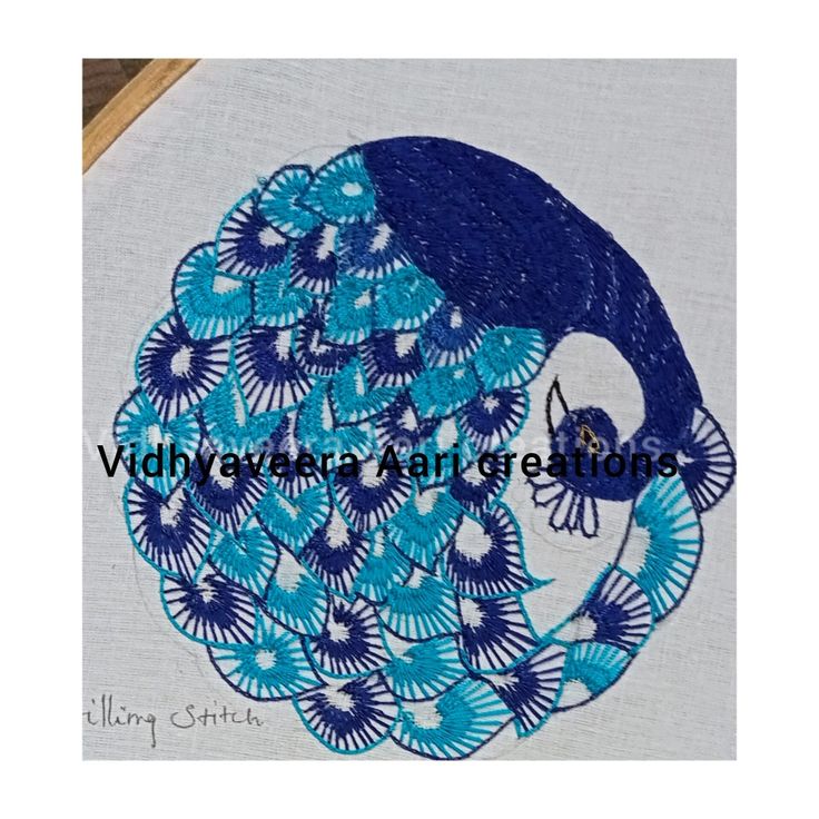 the embroidery design is blue and white with a bird on it's back end