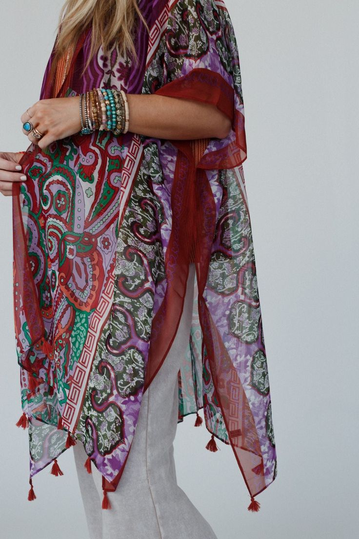 You'll add a stunning addition to your boho wardrobe with our Tabitha Floral Kimono, sure to become a cherished piece in your collection, adding a touch of bohemian glamour to every occasion! You'll love layering with this eye-catching kimono becasue it features: Lightweight, woven, slightly sheer fabric with a so pretty print throughout Relaxed and loose kimono silhouette Classic open front closure Loose kimono style sleeves and side slits created by single side seams So cute tassel details alo Red One-size Kimono For Festivals, Bohemian Long Kimono With Tassels, Spring Hippie Kaftan, One Size Bohemian Kaftan For Spring, Bohemian Kaftan For Spring, Multicolor Boho Print Kimono For Festival, Multicolor Bohemian Printed Kimono, Bohemian Multicolor Printed Kimono, Summer Paisley Print Kaftan