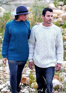 the man and woman are walking together in their sweaters, hats, and leggings