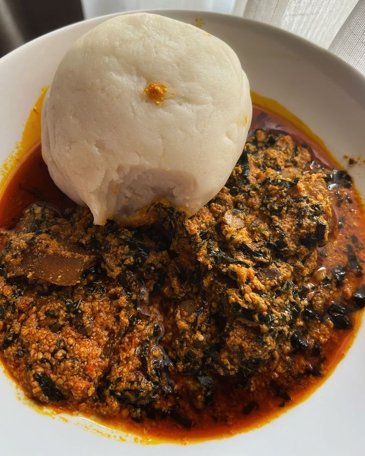 a white bowl filled with food on top of a table