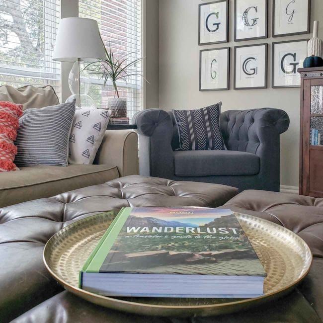 a living room with two couches and a book on the coffee table in front of it