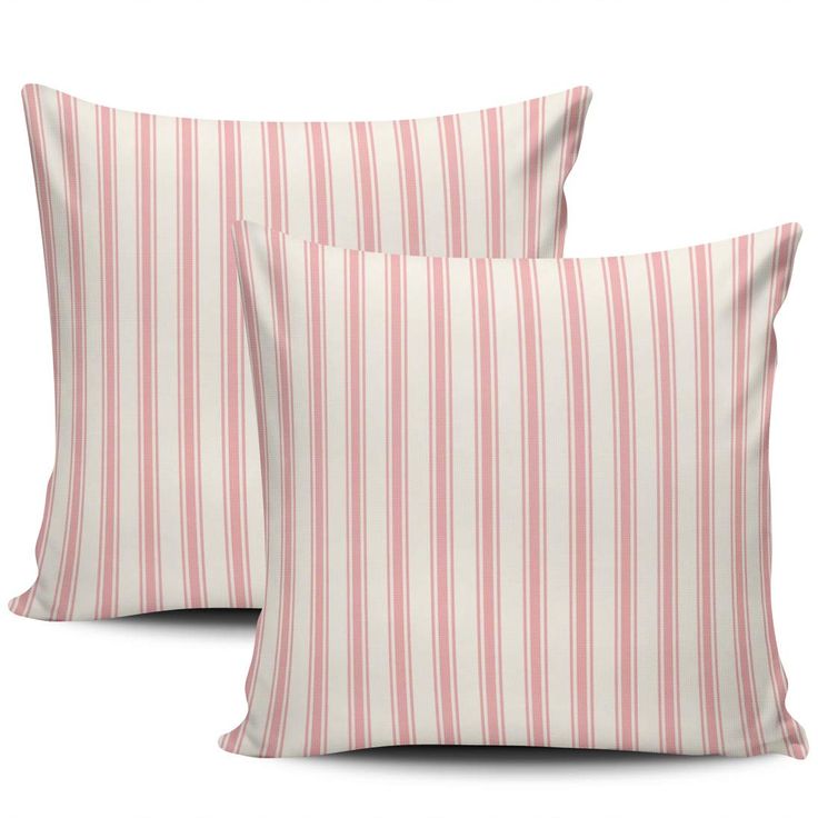 two pink and white striped pillows sitting next to each other