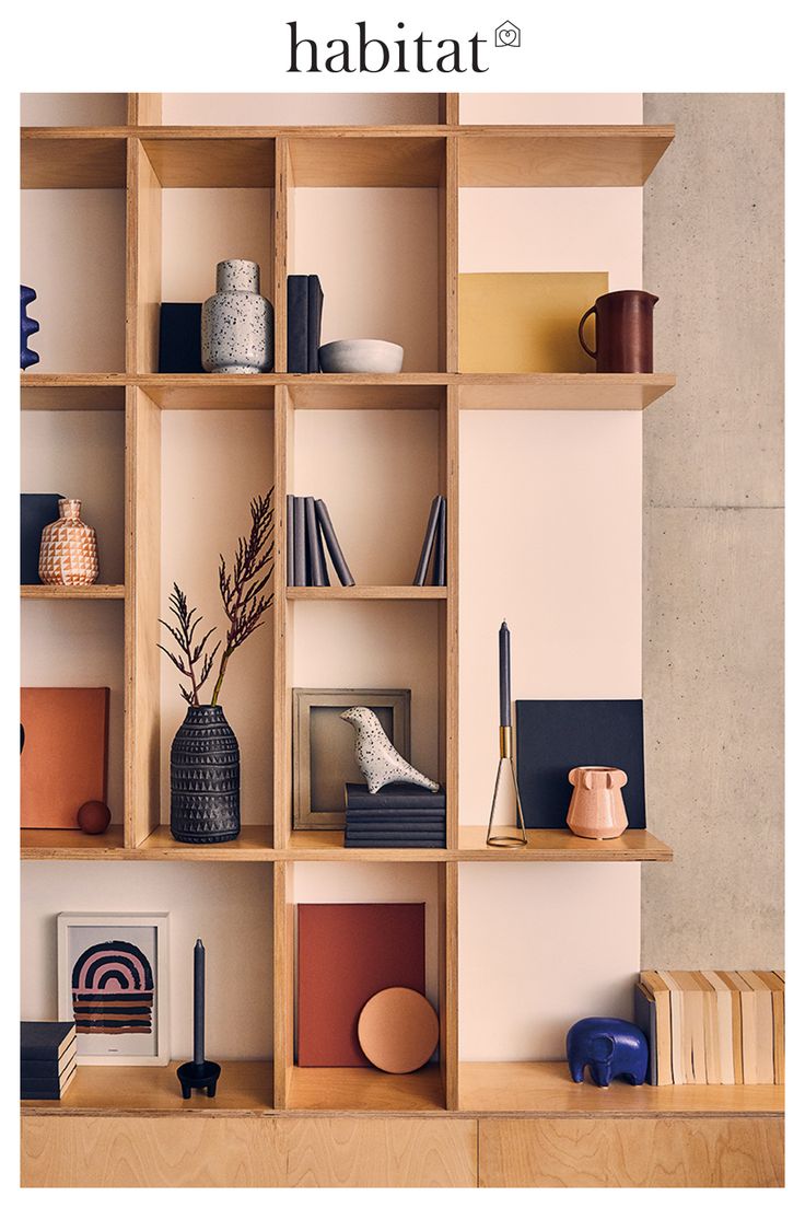 a shelf with books, vases and other items on it