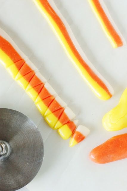 carrots and candy sticks on a white surface