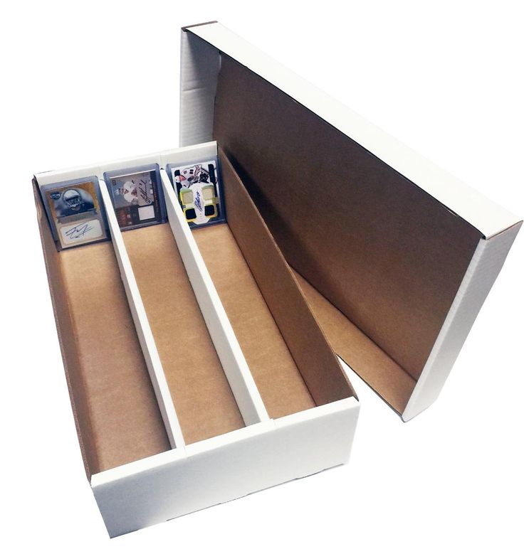 an open white box with pictures in it on a white surface, showing the inside compartments