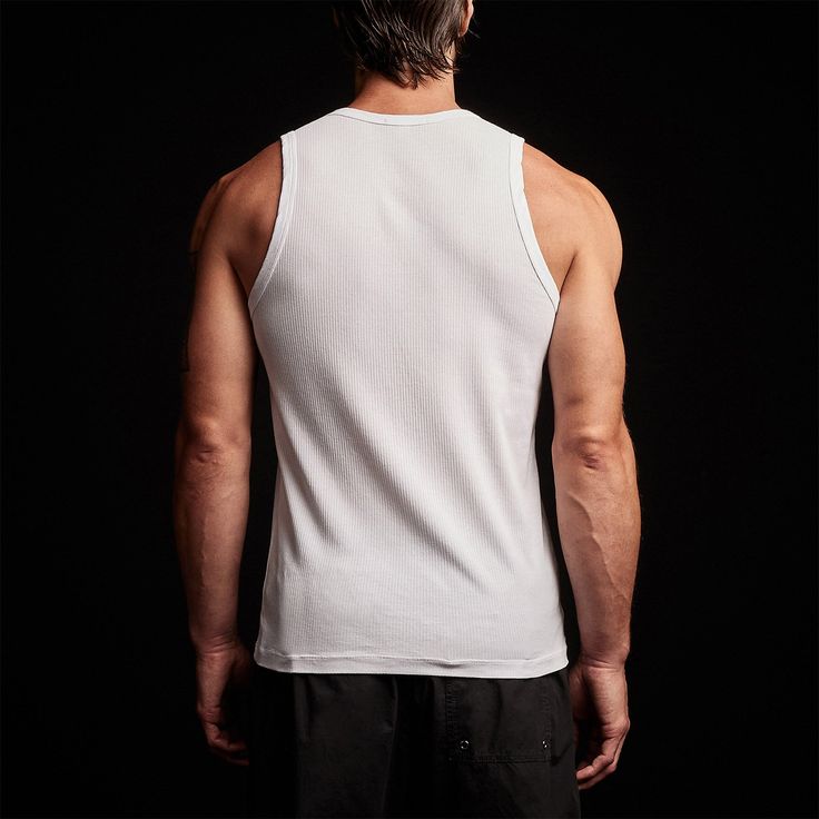 Our ribbed tank is made in our signature cotton lycra blend knit that features a soft, matte-like finish. Style details include crew neck line and a cover stitched bottom hem. Slim fit.Additional Information:• 95% Cotton, 5% Lycra• Machine wash cold with like colors, tumble dry low White Ribbed Crew Neck Tank Top, Fitted Cotton Muscle Tee With Scoop Neck, White Ribbed Casual Tank Top, Casual White Ribbed Tank Top, White Ribbed Tank Top, Casual Style, White Classic Crew Neck Tank Top, Fitted Basic Cotton Muscle Tee, White Ribbed Sleeveless Tank Top, White Sleeveless Ribbed Tank Top