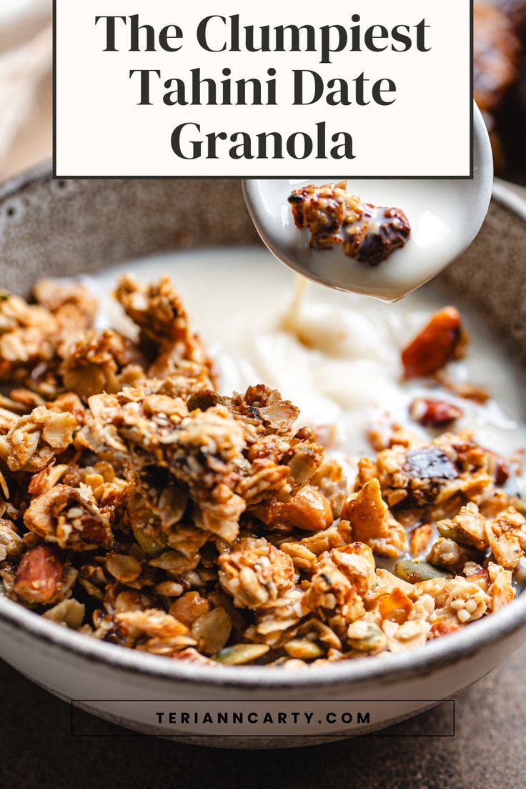 a bowl filled with granola next to a spoon