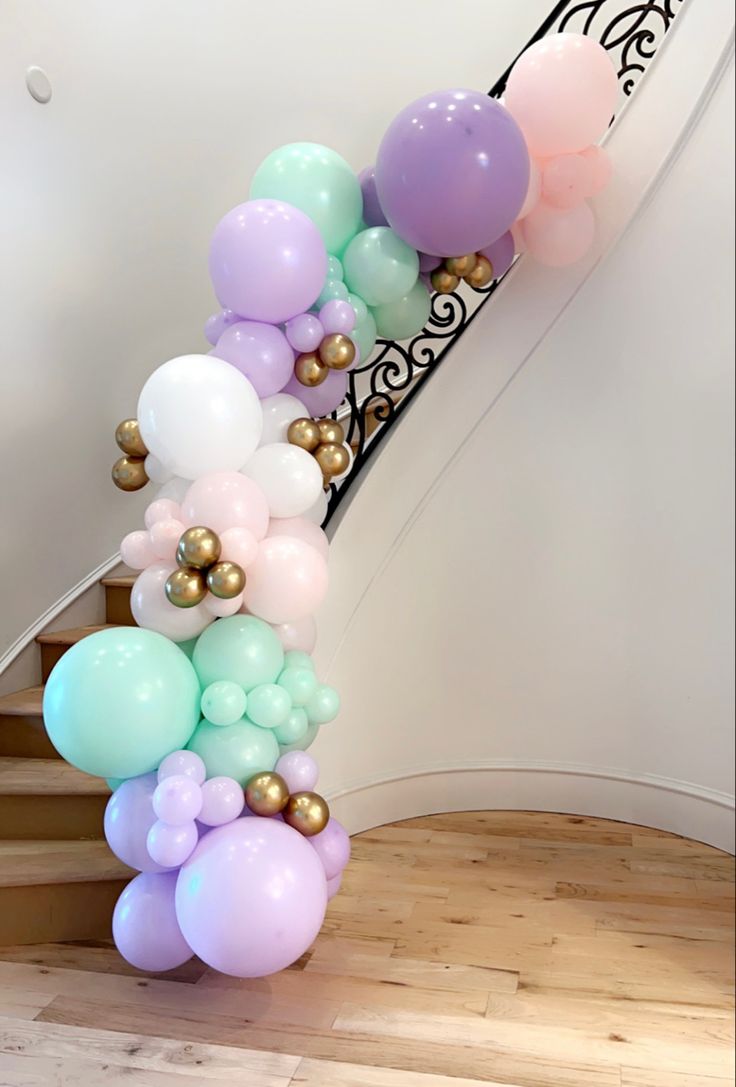 some balloons are hanging down the stairs