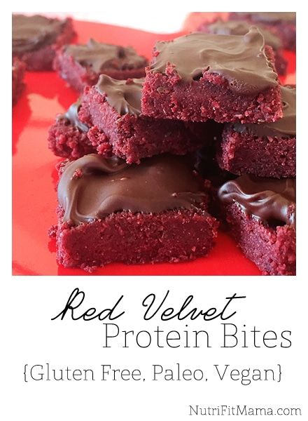 red velvet protein bites stacked on top of each other with chocolate frosting in the middle