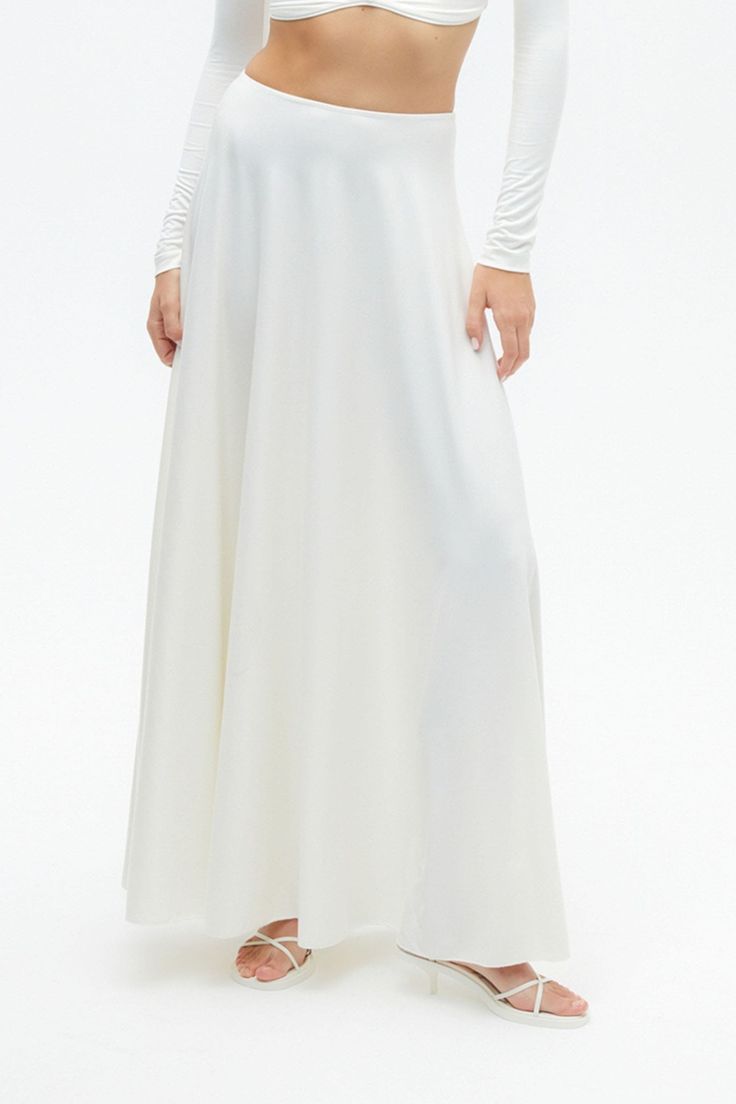 The long skirt is back in a big way, and this asymmetric option is a winning way to wear the trend. Dry clean Material: 60% Viscose, 31% Nylon, 9% Elastane High rise Officially licensed Imported Brand: Nocturne Model Product Size: S Model Size: Height 5'10 / Bust 29.5 in / Waist 23 in / Hips 34 in True the size Cream Bottoms For Spring Evening, Cream Long Flowy Skirt, Cream Flared Maxi Skirt With Lining, White Maxi Length Lined Bottoms, Chic Flowy Full Length Maxi Skirt, White Maxi Length Bottoms With Lined Skirt, Cream Maxi Skirt With Relaxed Fit And Lining, Cream Flowy Long Skirt, Cream Flowy Flared Maxi Skirt