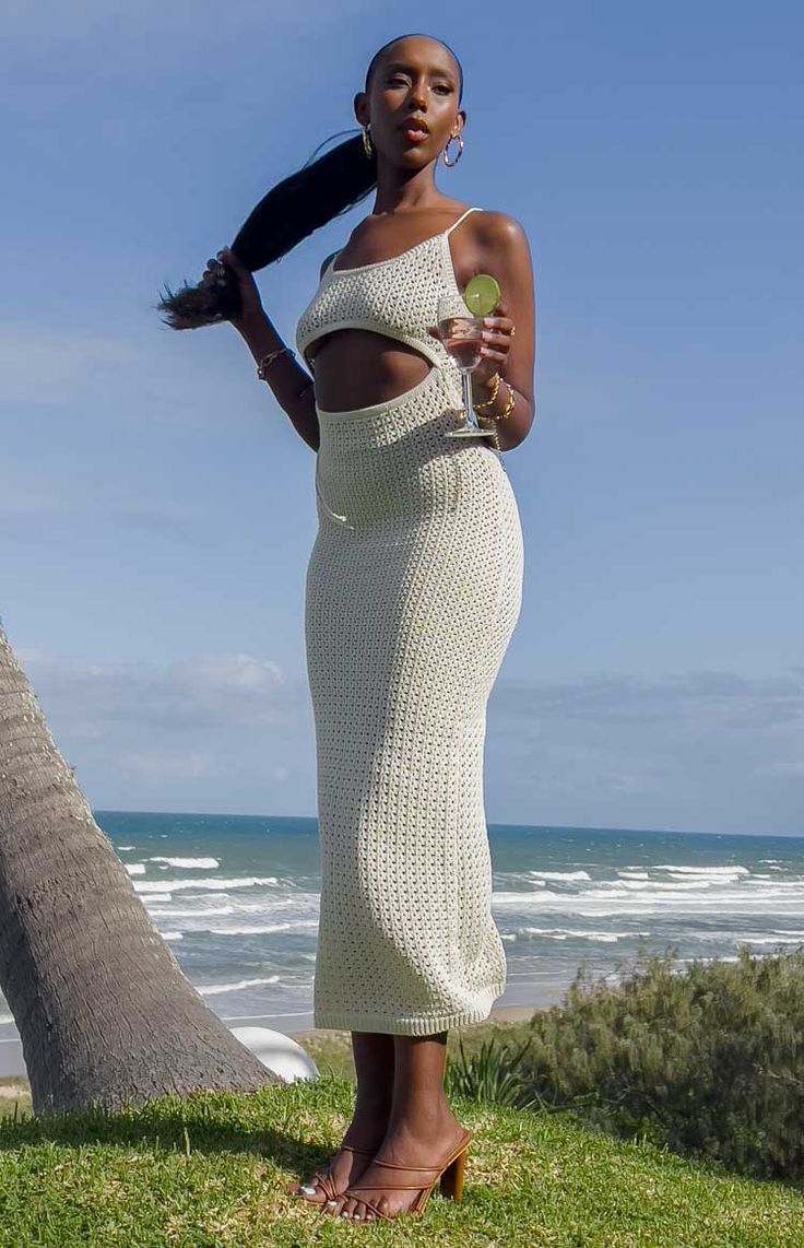 Beige Crochet Knit Maxi Dress Going on a beach getaway? This crochet knit midi dress is perfect for the warmer weather - going from beach to bar. Pair with sandals and sunnies for a gorg look. Maxi length Crochet fabric Cutout at front Tie up at back Backless Sheer Unlined Heavyweight fabric with stretch Open Knit Midi Summer Dress, Open Knit Midi Length Dress For Vacation, Summer Crochet Dress For Poolside Vacation, Open Knit Midi-length Vacation Dresses, Chic Knit Midi Dress For Vacation, Chic Knit Midi Dress For Summer, Casual Summer Crochet Dress For Poolside, Casual Crochet Dress For Summer Poolside, Beachy Midi Dress For Brunch During Beach Season