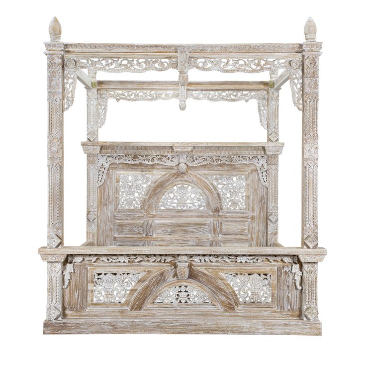 an old wooden bed with intricate carvings on the headboard and foot board, isolated against a white background