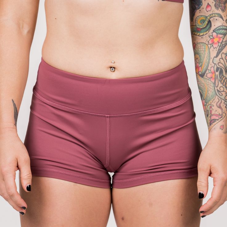 These Booty Shorts are all the rage! Spandex athletic shorts that move with you - not against you. Our Rusty Shorts, a pair of our classic solid color booty shorts, are a must-have for every woman that is serious about her fitness journey. Savage Classic Booty Shorts are custom-made with a perfect blend of nylon and spandex. These dusty rose shorts feature 4-way stretch performance fabrics. They're soft, comfortable, squat proof, and stay in place so you can achieve full range of motion in and o Solid Sport Shorts, Solid Athletic Shorts With Contoured Waistband For Training, Solid Color Squat Proof Gym Bottoms, Solid Squat-proof Gym Bottoms, Solid Color Training Bottoms Short, Moisture-wicking Short Bottoms For Cheerleading, Cheerleading Activewear With Built-in Shorts, High Stretch Athletic Shorts With Built-in Shorts, Fitted Squat Proof Shorts