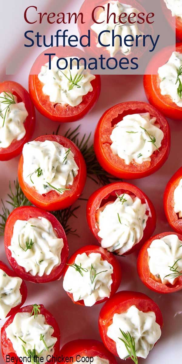 cream cheese stuffed cherry tomatoes with dill sprig on top and text overlay that reads, cream cheese stuffed cherry tomatoes