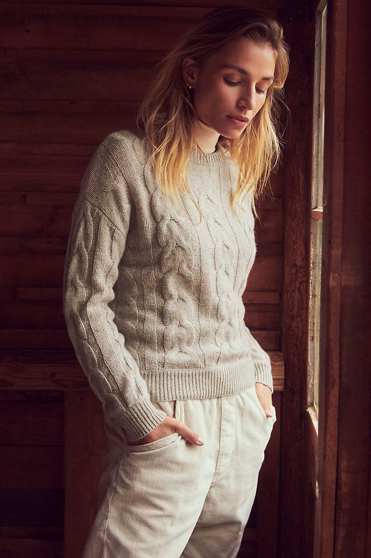 Good luck keeping your head out of the clouds when you put on the 100% cashmere Eden pullover. The lavish, swirling cable design of this beyond-cozy chunky knit complements its divine texture and heathery hues. With a relaxed drop-shoulder design, this dreamy sweater offers a contemporary, slightly cropped length for a feminine, fashion-forward look. Throw it on with practically anything for an oh-so-soft statement that will give a glow to even the grayest of days. Elegant Stretch Cable Knit Sweater, Chic Cable Knit Cashmere Sweater, Elegant Merino Wool Cable Knit Sweater, Luxury Cable Knit Long Sleeve Sweater, Luxury Cotton Cable Knit Sweater, Soft Autumn Color Palette, Sheepskin Coat, Winter Outfits Men, Cashmere Turtleneck