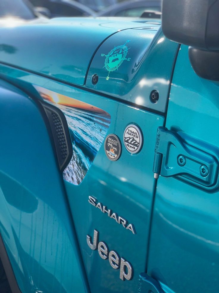 the side view of a jeep with stickers on it