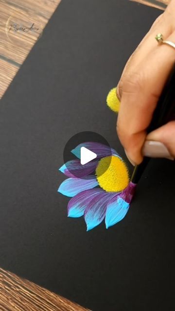 someone is drawing a flower with colored pencils