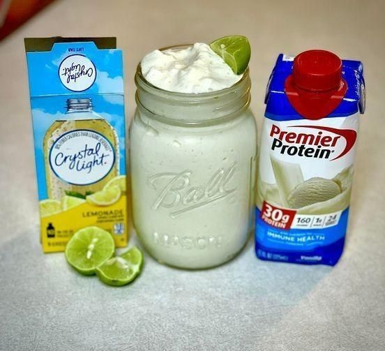 the ingredients to make this drink are displayed on the counter top, including yogurt, lemonade, and lime juice