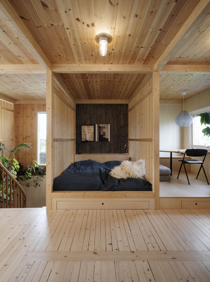 a bedroom with wooden walls and flooring