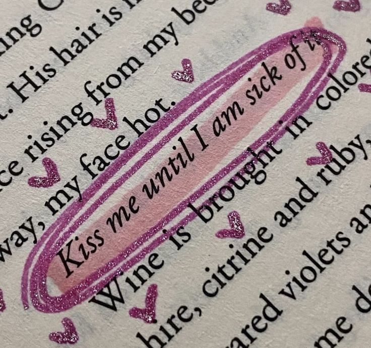 an open book with writing on it and pink ink in the middle, surrounded by hearts