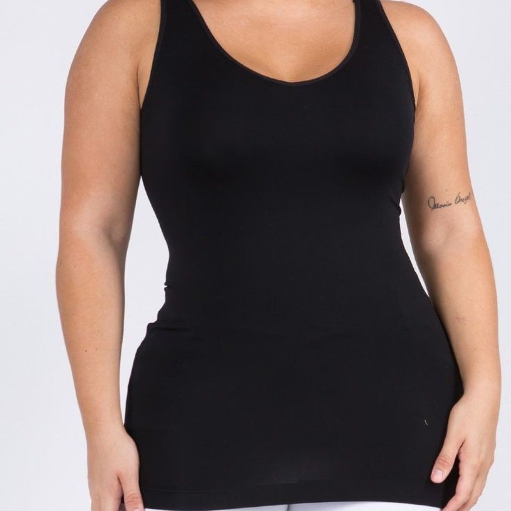 This Seamless Tank Makes Styling Any Outfit A Breeze! Featuring A V-Neckline And Fitted Silhouette In A Buttery, Soft Fabric That's Very Comfortable For Wearing All Day. Wide Shoulder Straps V-Neckline Back Scoop Neck Fitted Silhouette Seamless Design Buttery Soft Fabrication With Stretch Pull On/Off Longline Hem 92% Nylon, 8% Spandex Black Seamless Tank Top With Built-in Bra, Black Seamless Tops With Built-in Bra, Black Camisole With Built-in Bra For Layering, Black Tops With Built-in Bra And Seamless Fabric, Stretch Shapewear Tops For Workout, Black Stretch Seamless Tank Top, Stretch Compression Top For Workout, Workout Shapewear Tops, Seamless Fabric Racerback Tank Top